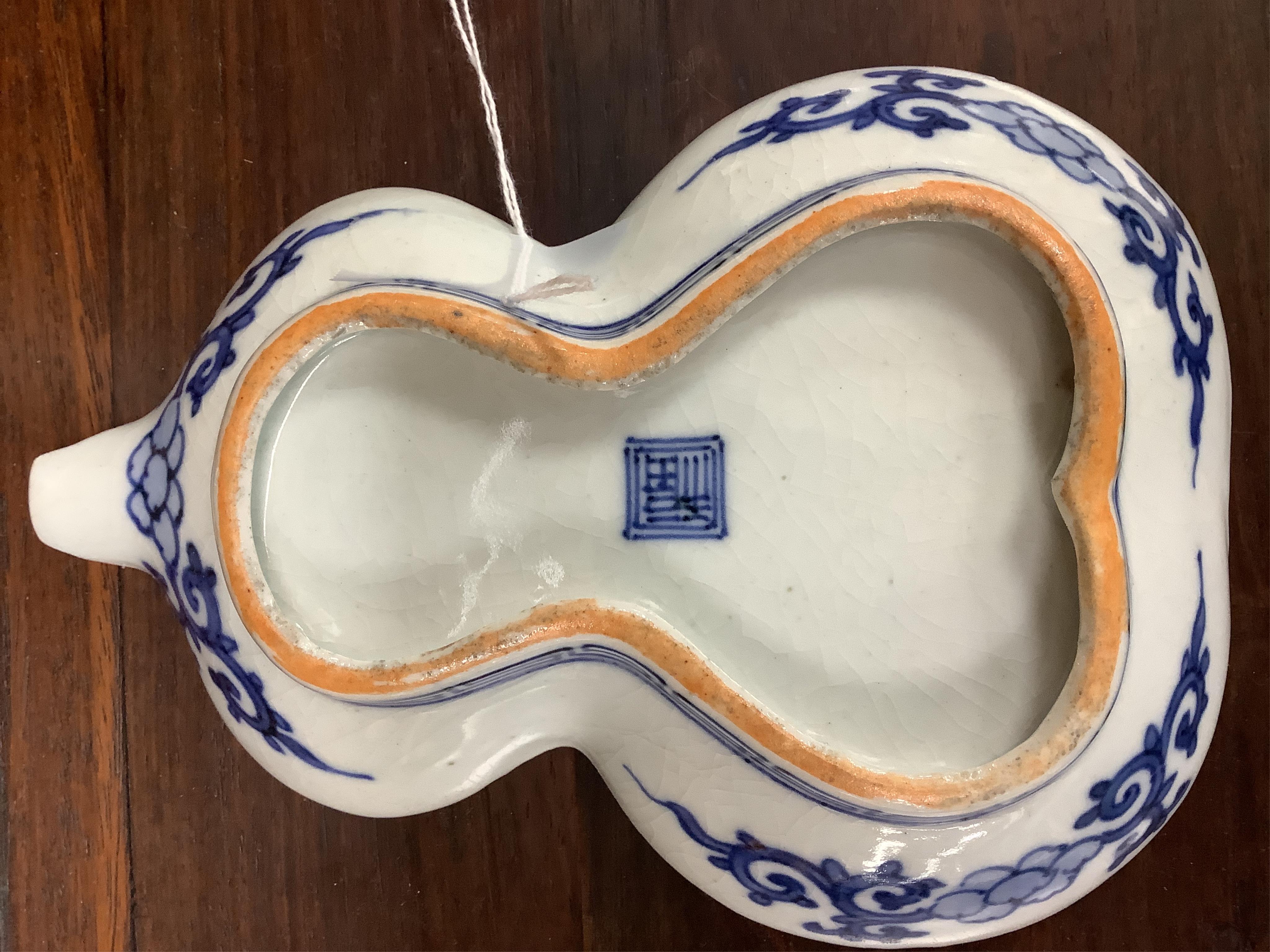 A Japanese seated porcelain figure of Kwannon, an Imari dish and a kakiemon style dish, largest 35cm diameter (3). Condition - blue dish good, others poor to fair